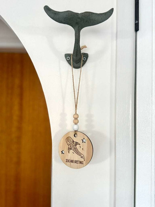 Wooden Christmas decoration whale shark bauble with jute string and beads hanging on wall hook