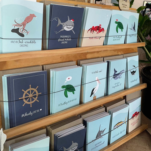 10 cards bundle with ocean-themed greeting cards and envelopes displayed on wooden rack