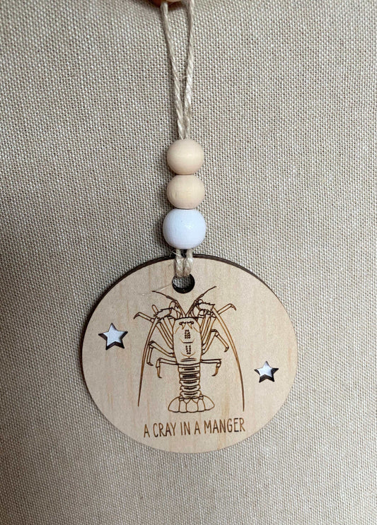 Wooden Christmas decoration with etched crayfish design and jute string hanging ornament