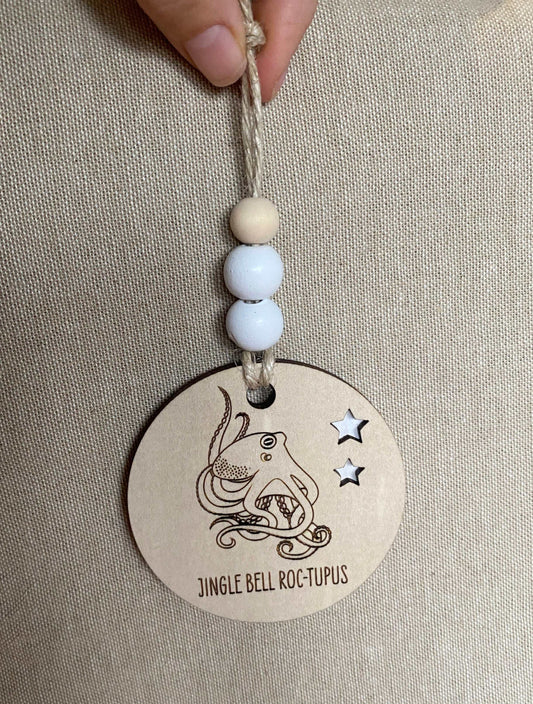 Wooden Christmas decoration featuring an octopus design with jingle bell text and star cutouts