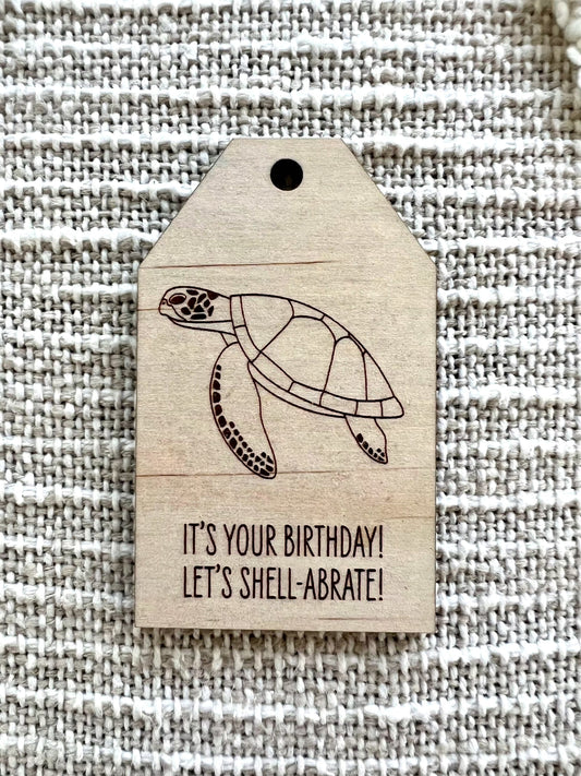Wooden birthday gift tag with green turtle design and birthday message on plywood