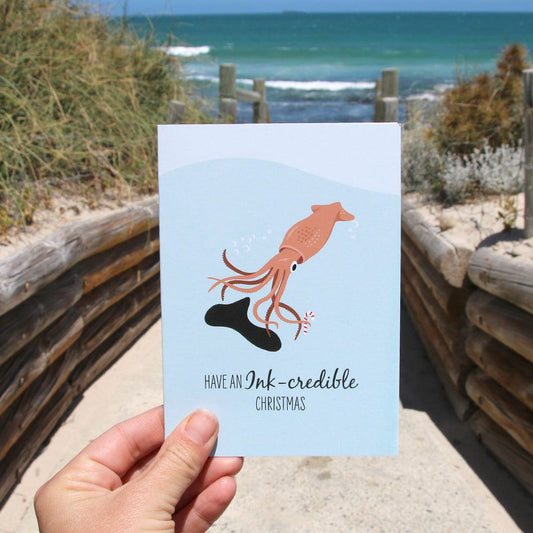 Christmas card featuring a funny Arrow Squid design with ocean theme and holiday greeting