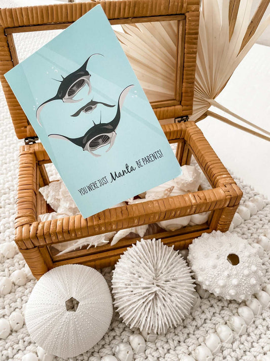 Baby card with manta ray design and ocean theme in wicker box with sea urchin decor