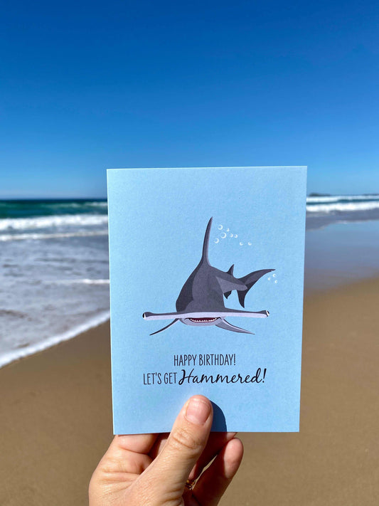Birthday card featuring a humorous hammerhead shark design with ocean background